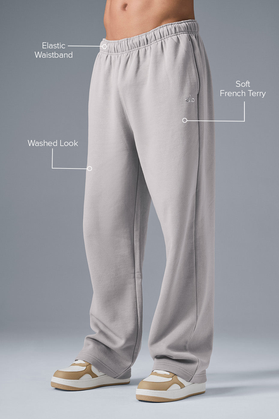 Close-up of the chrome ALO logo detail on the sweatpants