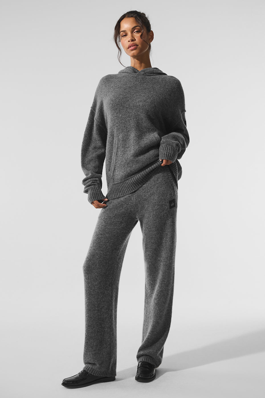 Men's cashmere sweatpants in platinum grey laid out for lounging
