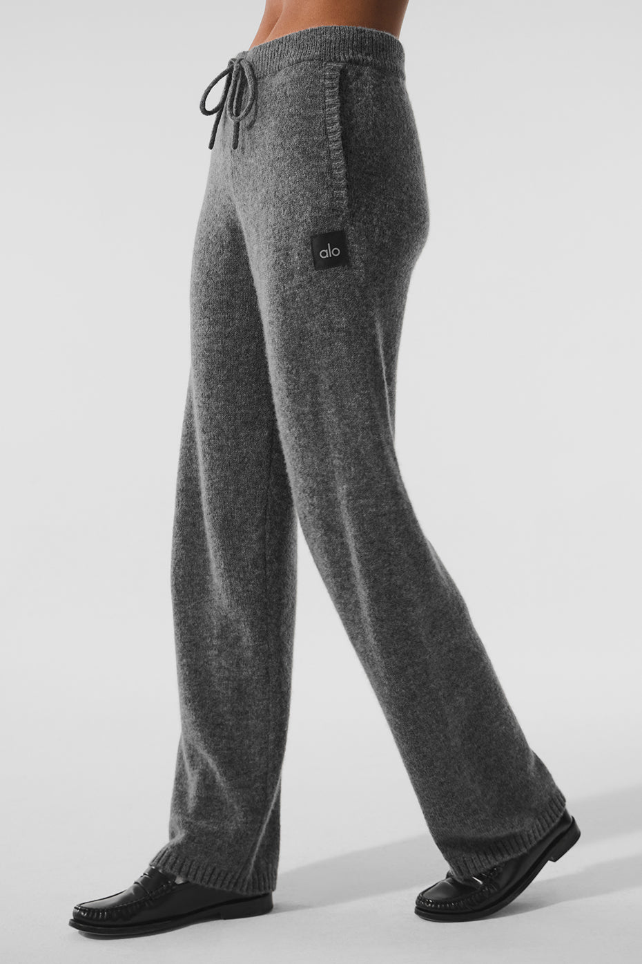 Mens cashmere sweatpants in platinum grey laid out for lounging