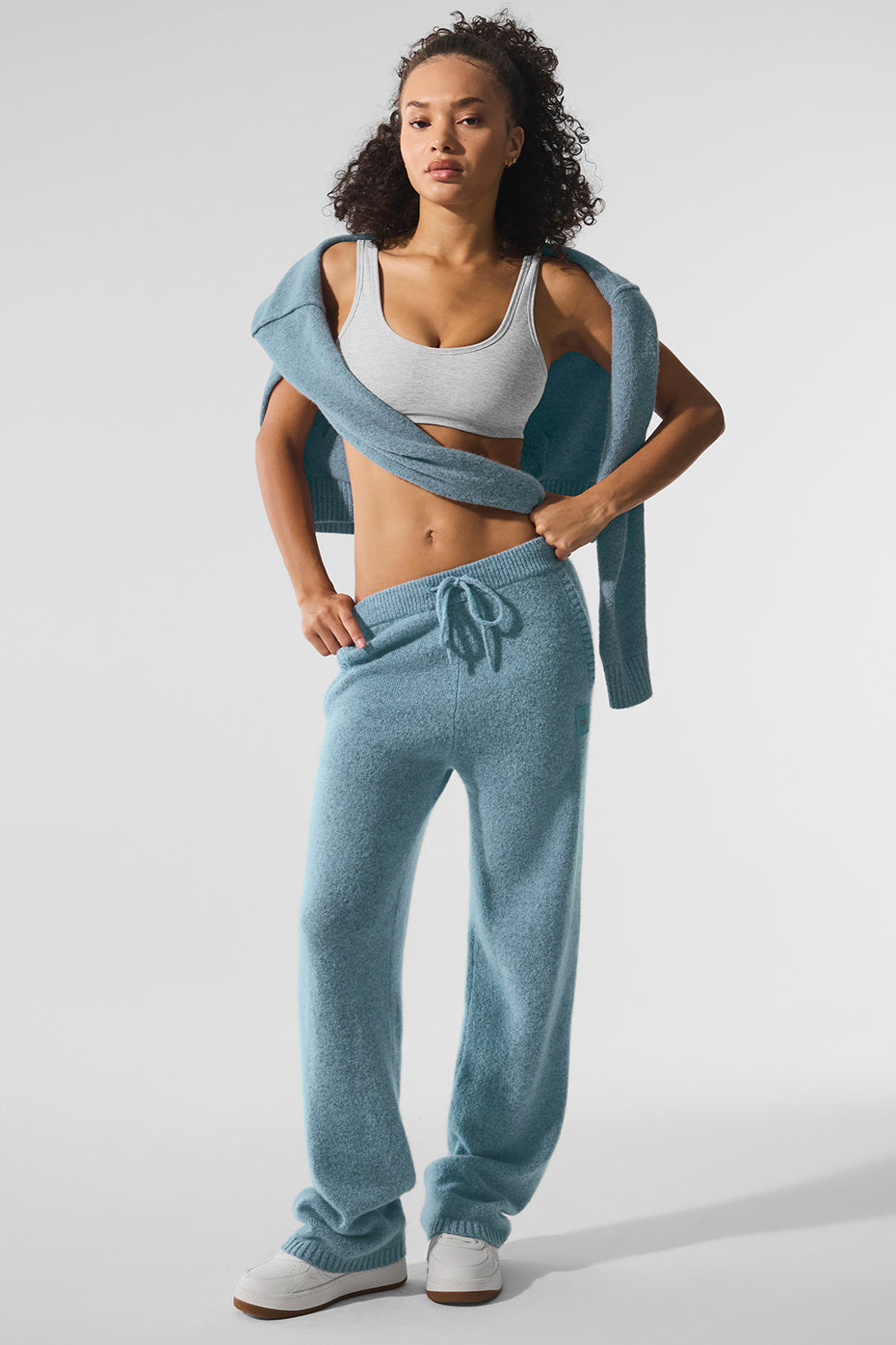 Celestial blue cashmere lounge pants on a stylish model.