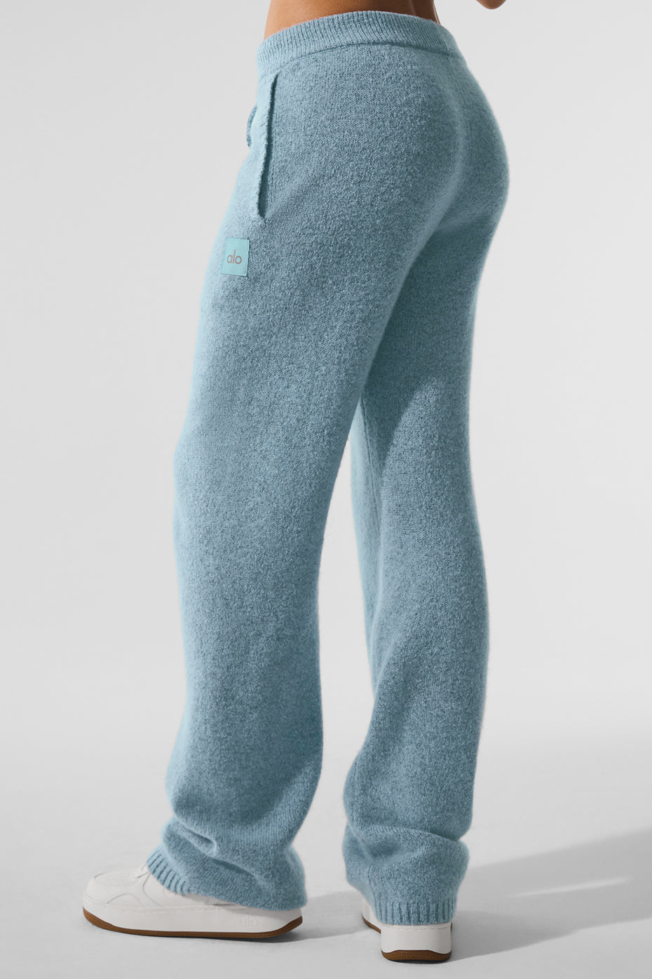 Celestial blue cashmere lounge pants on a stylish model.