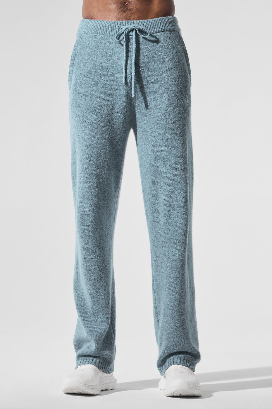 Men's cashmere sweatpants in celestial blue laid out for lounging