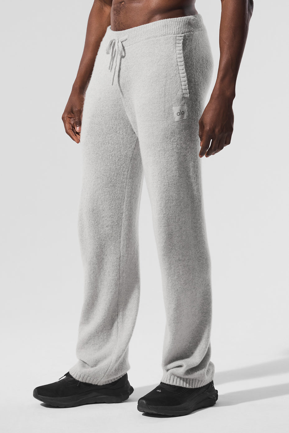 Pearl Grey Heather cashmere pants showcased in a cozy living room setting.