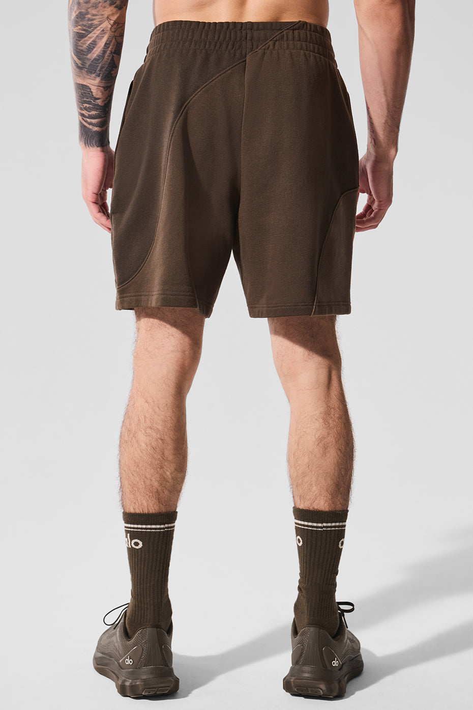 Model wearing espresso fleece shorts in casual setting