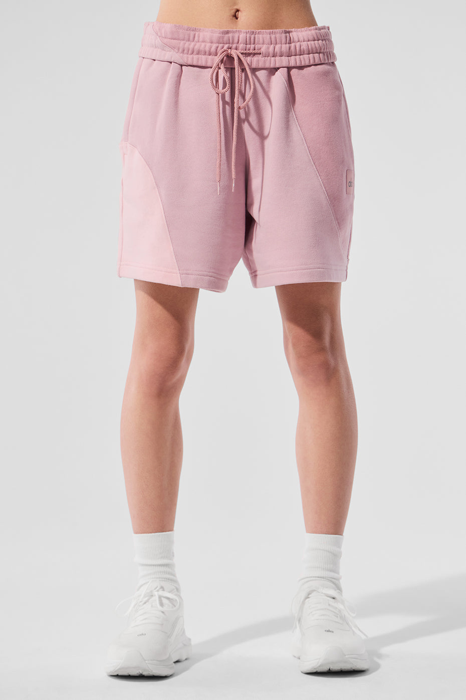 Front view of sunset pink women's fleece shorts with wave pattern.