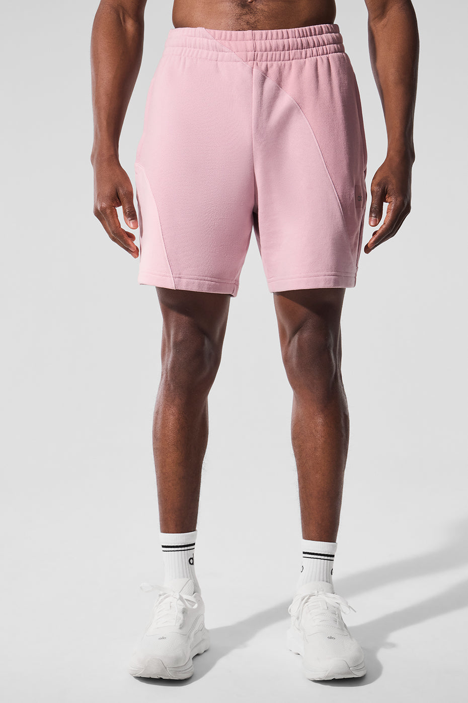 Front view of women's fleece shorts in hot pink with ripple stitching, styled for workouts