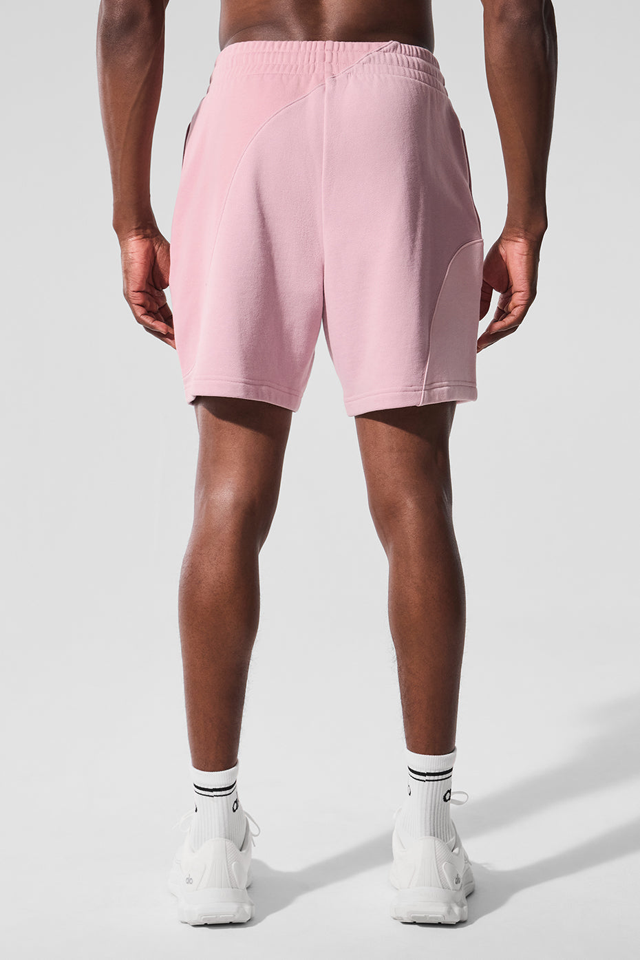 Side profile of light pink workout shorts, modeled on outdoor trail in Virginia