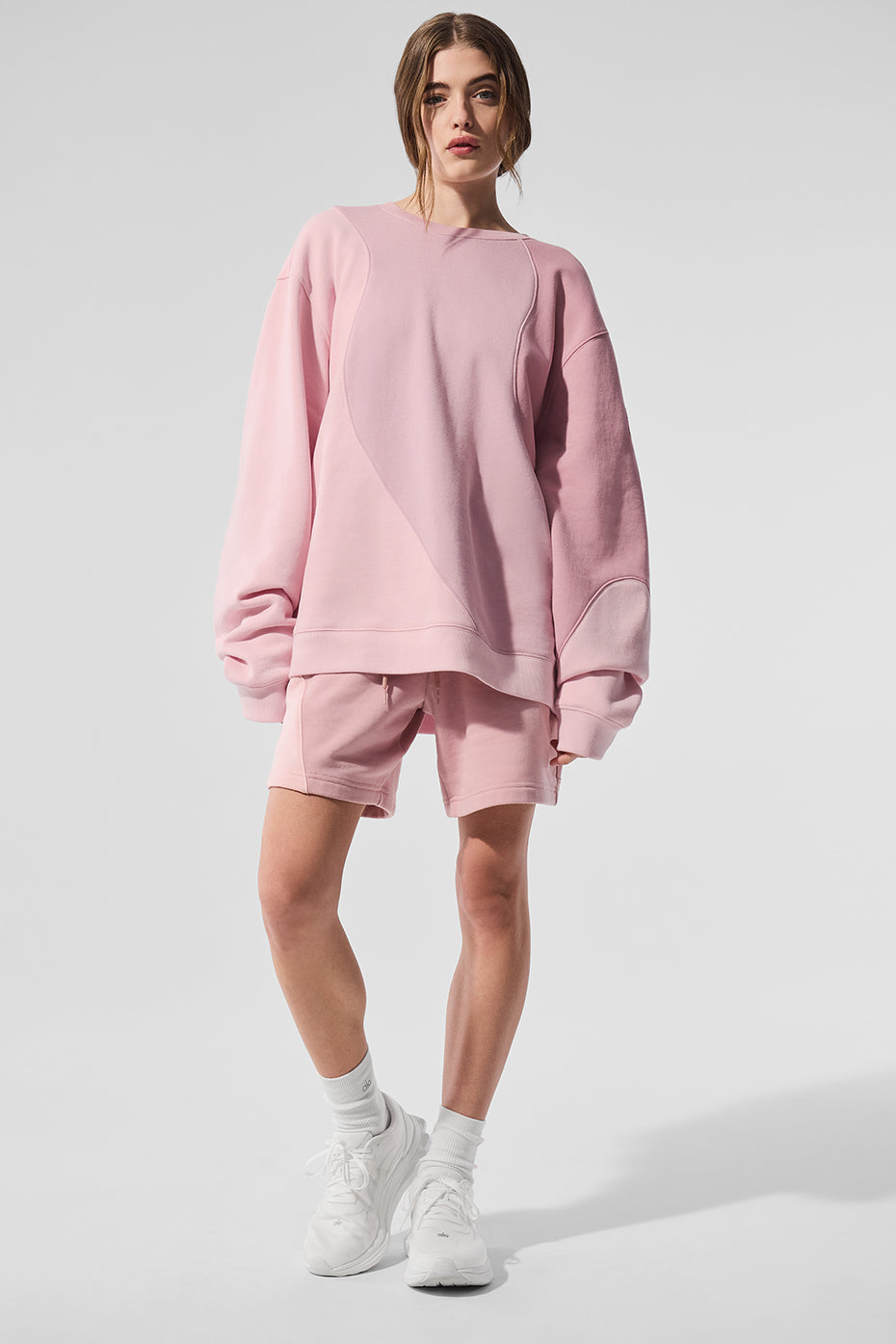 Front view of sunset pink womens fleece shorts with wave pattern.