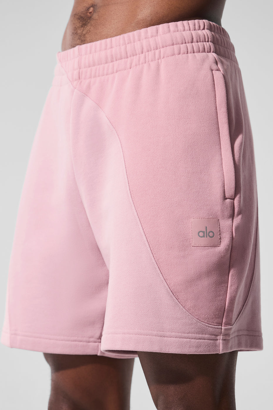 Front view of womens fleece shorts in hot pink with ripple stitching, styled for workouts