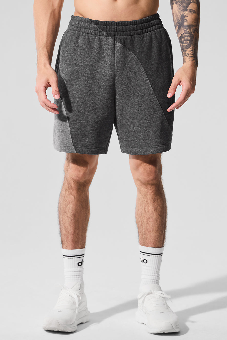 Front view of men's fleece shorts in dark heather grey, showcasing the wave pattern.