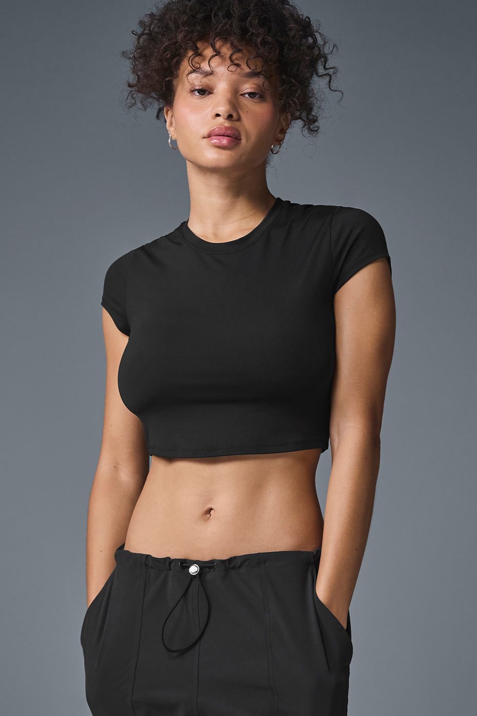 Front view of Alosoft Black Crop Top for yoga practice.