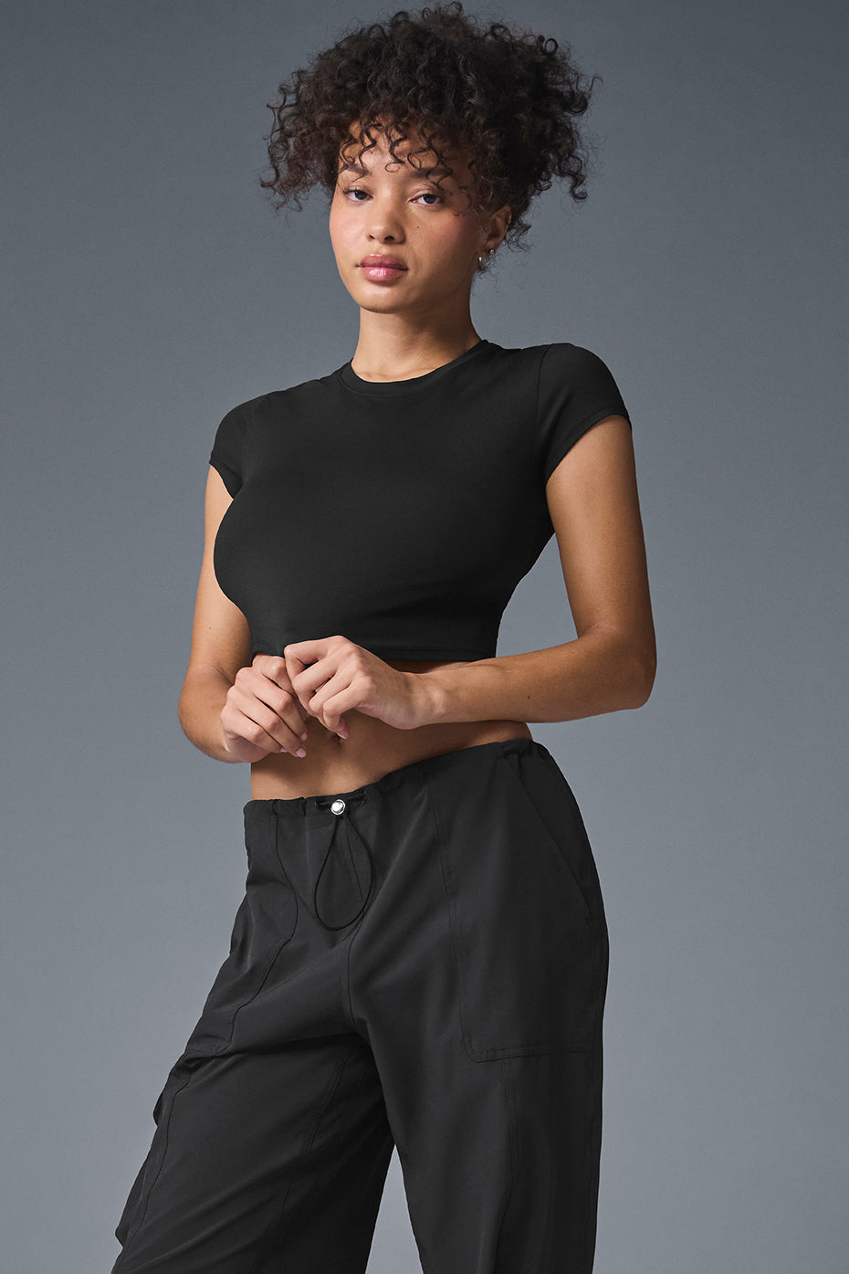 Front view of Alosoft Black Crop Top for yoga practice.