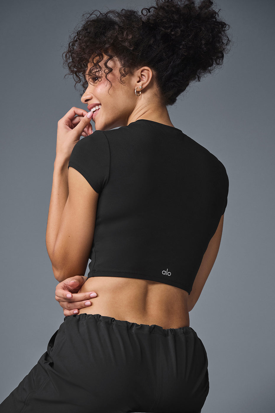 Casual wear image of the Alosoft Crop Top paired with leggings.