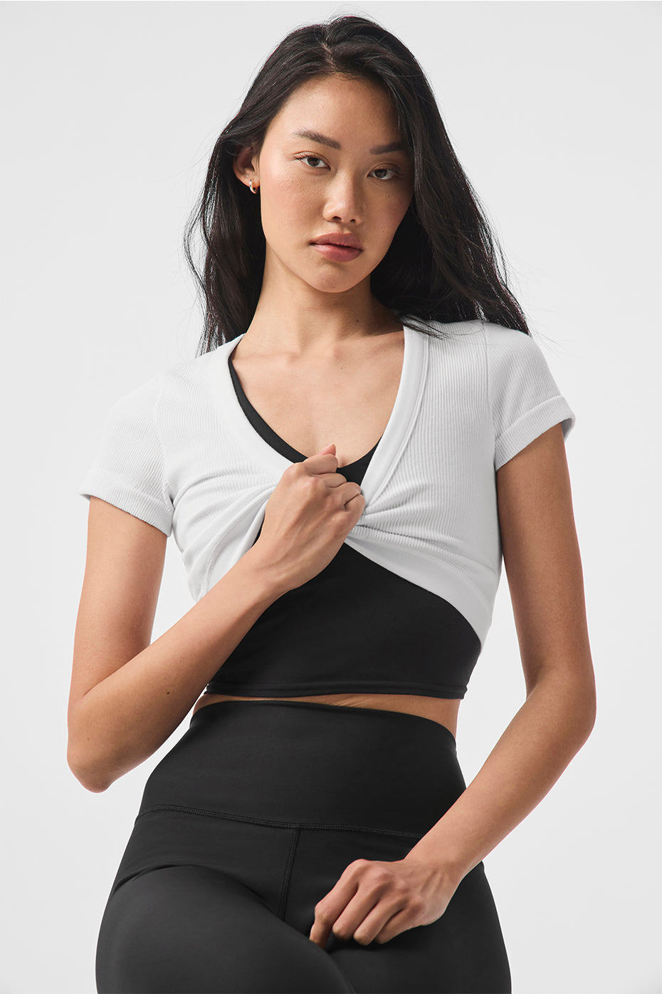 Close-up of the ribbed fabric and curved hem of the Serene crop top.