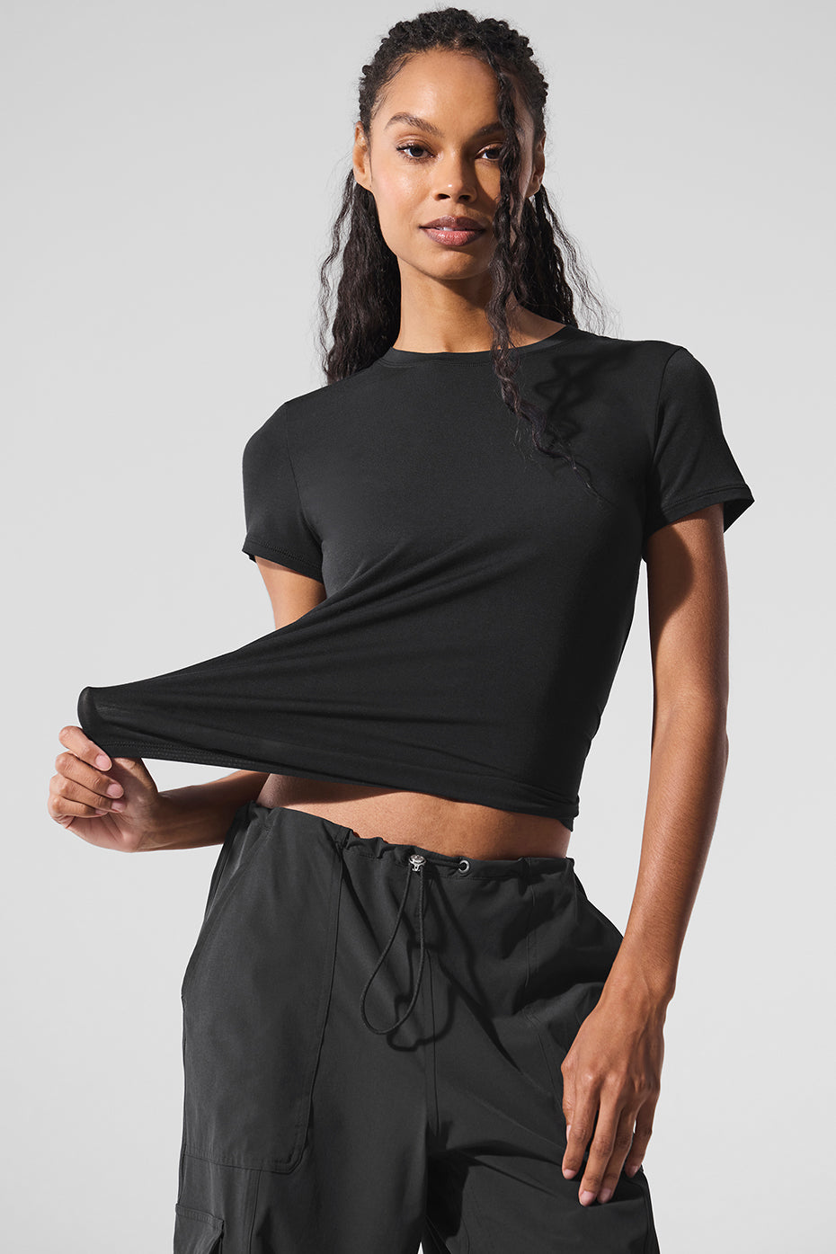 Black short sleeve t shirt dress alternative styled with high-top sneakers for a city-ready look