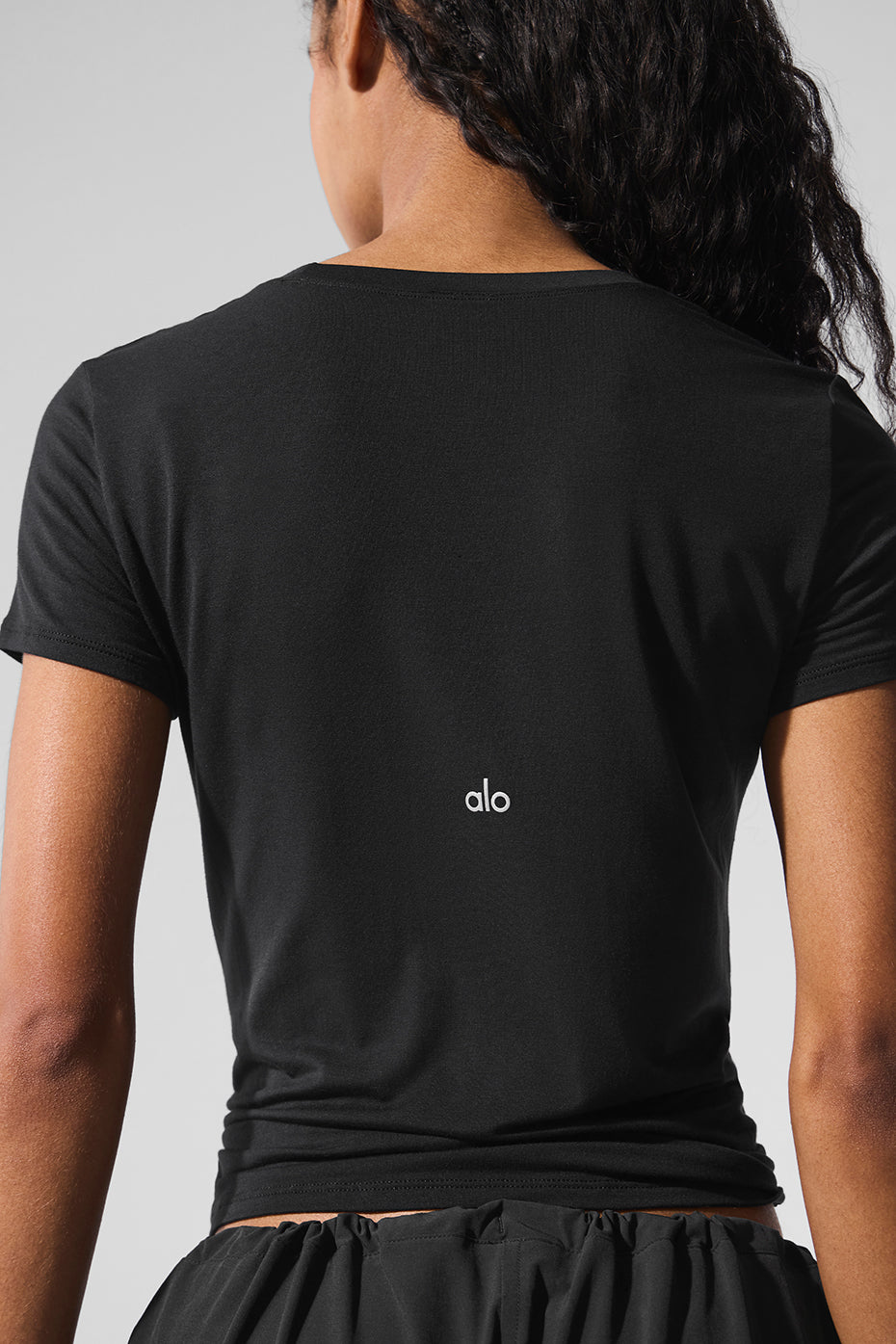 Front view of woman wearing short sleeve black t shirt women prefer for daily wear