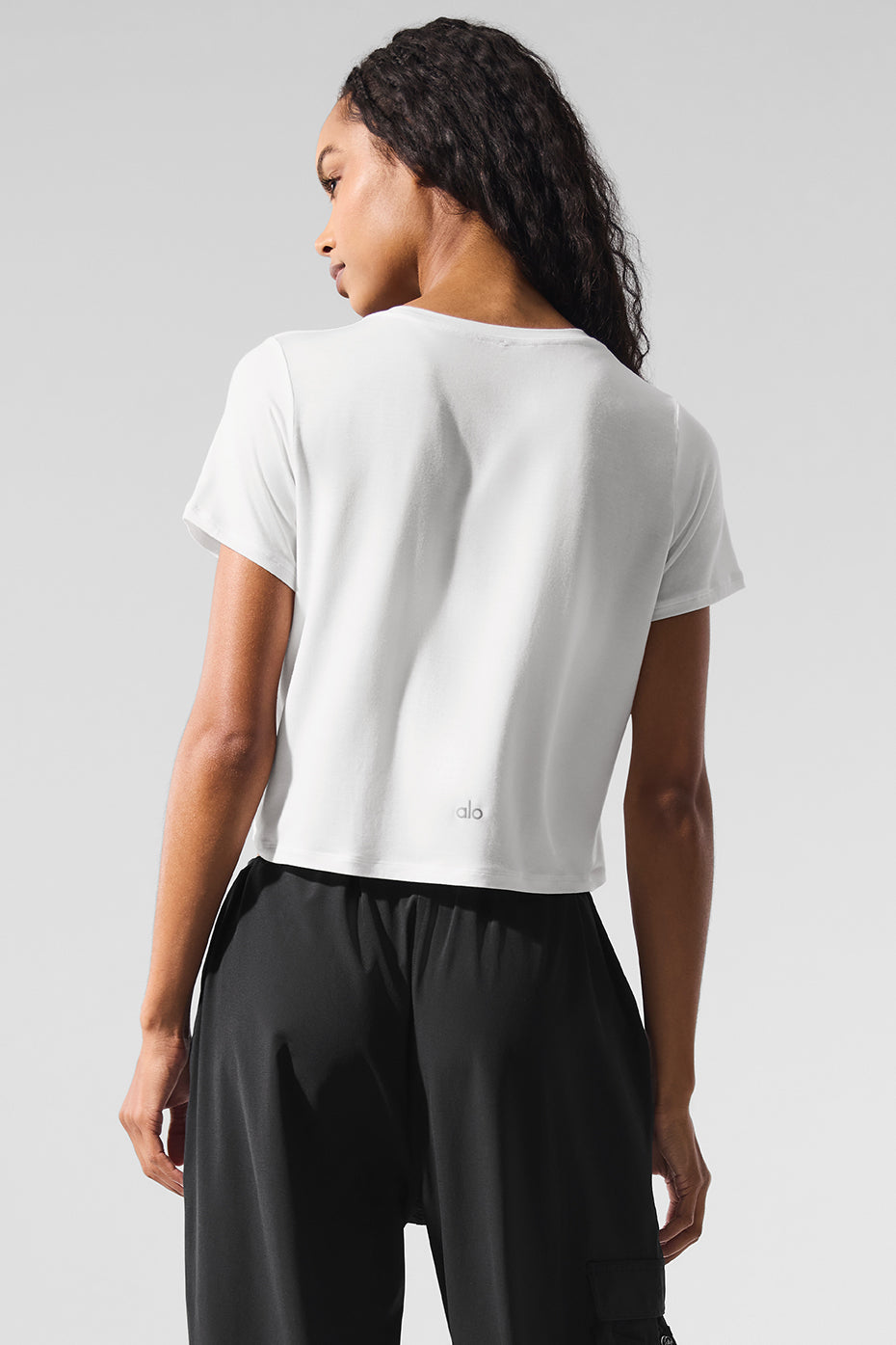Model styling the cropped t-shirt with casual bottoms for everyday wear