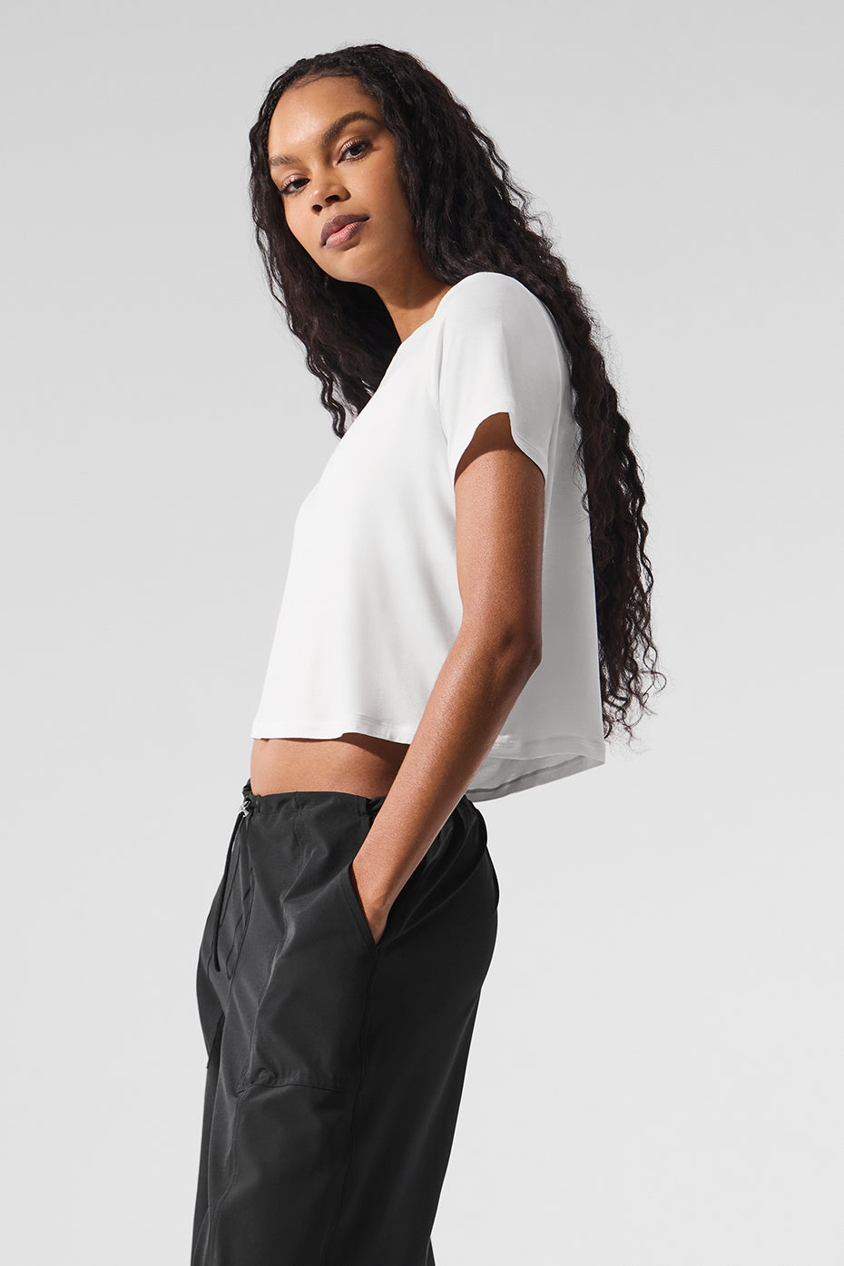 Front view of the cropped t-shirt paired with light layers for versatile style