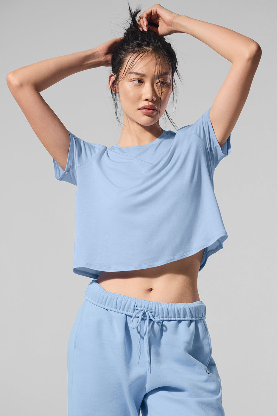Seashell Blue cropped short sleeve top styled with high-waisted jeans