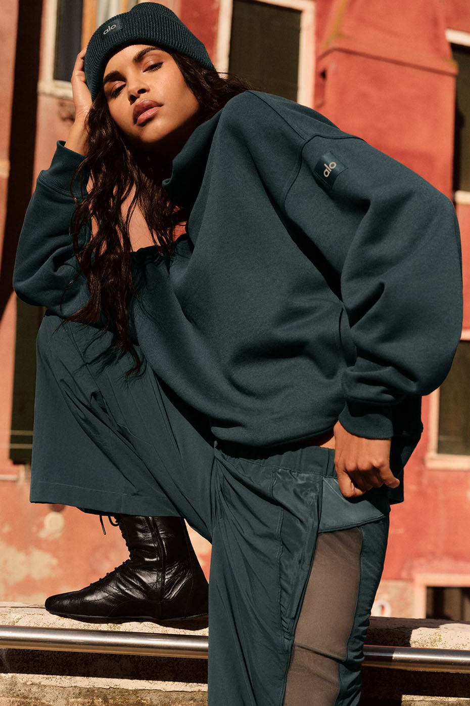 Front view of oversized turtleneck sweater styled with jeans in an urban setting.