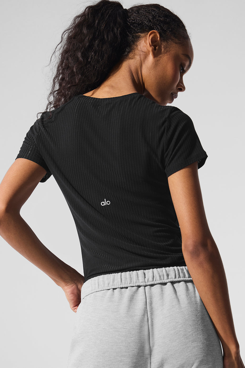 Close-up of the ribbed fabric texture on the black crewneck tee.