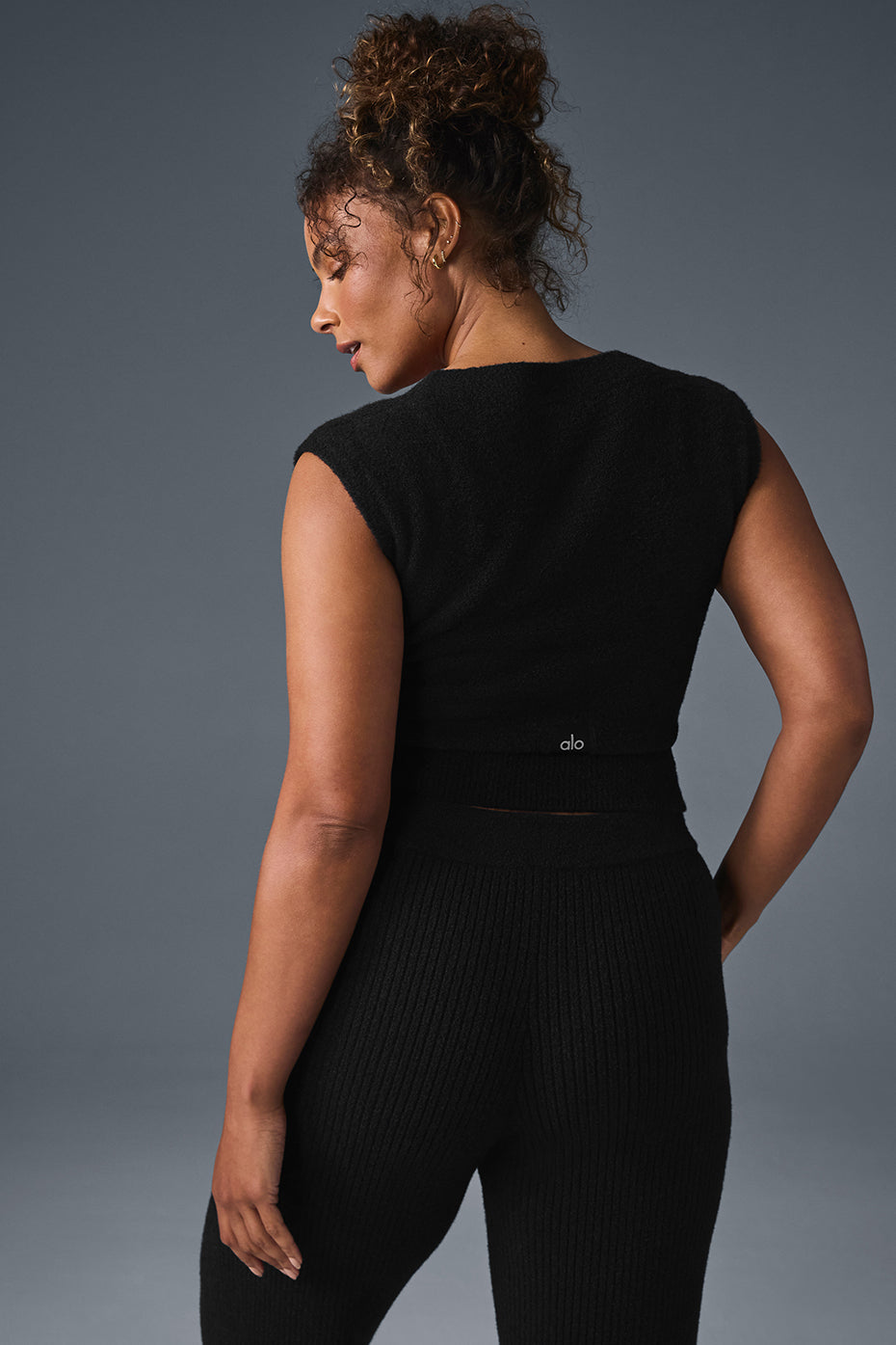 Front view of black sweater women style paired with trousers