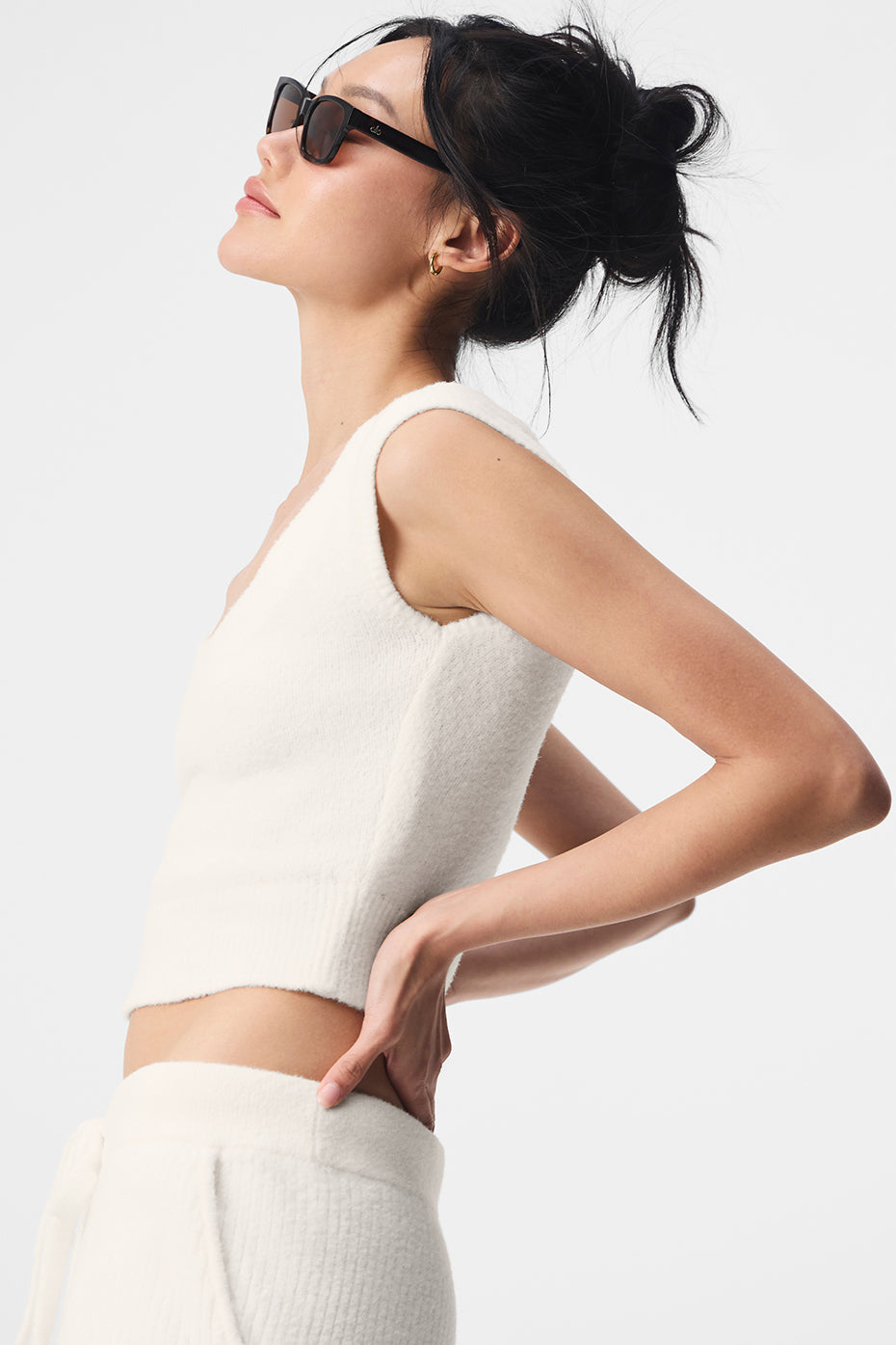 Model wearing the ivory short sleeve sweater with stylish pants.