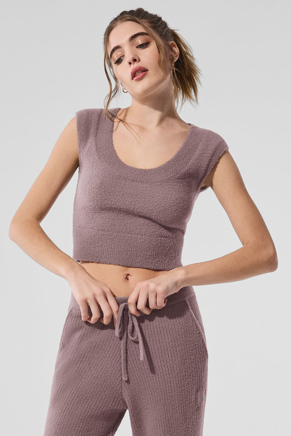 Close-up of the scooped neckline and cap sleeves of the womens cashmere sweater.