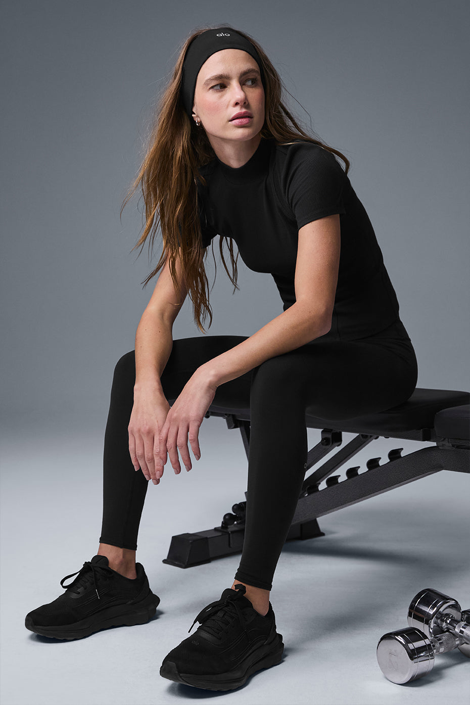 Front view of black ribbed tank top with mock neck on a model