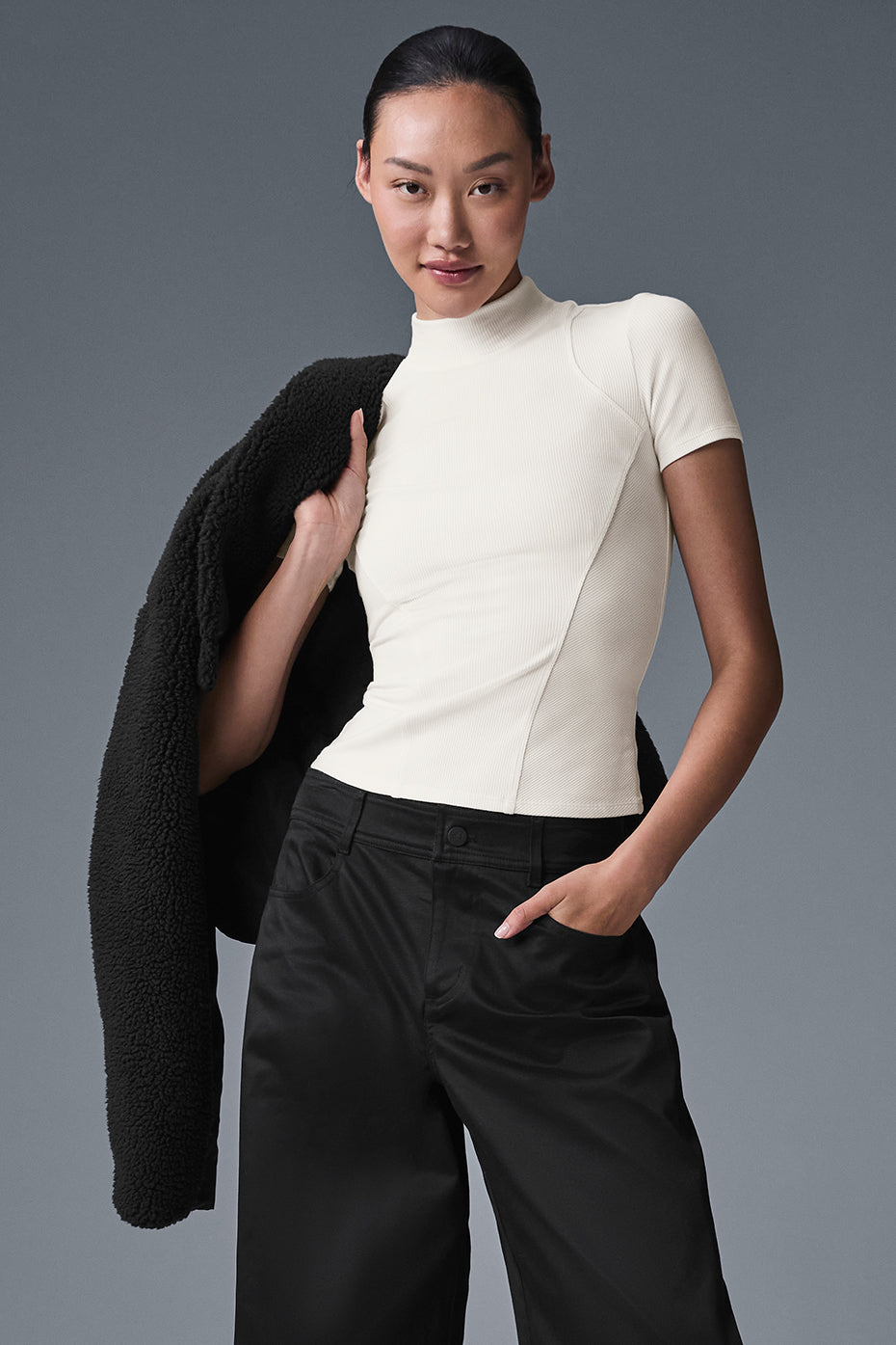 Front view of chic ivory mock neck short sleeve top, styled with jeans.