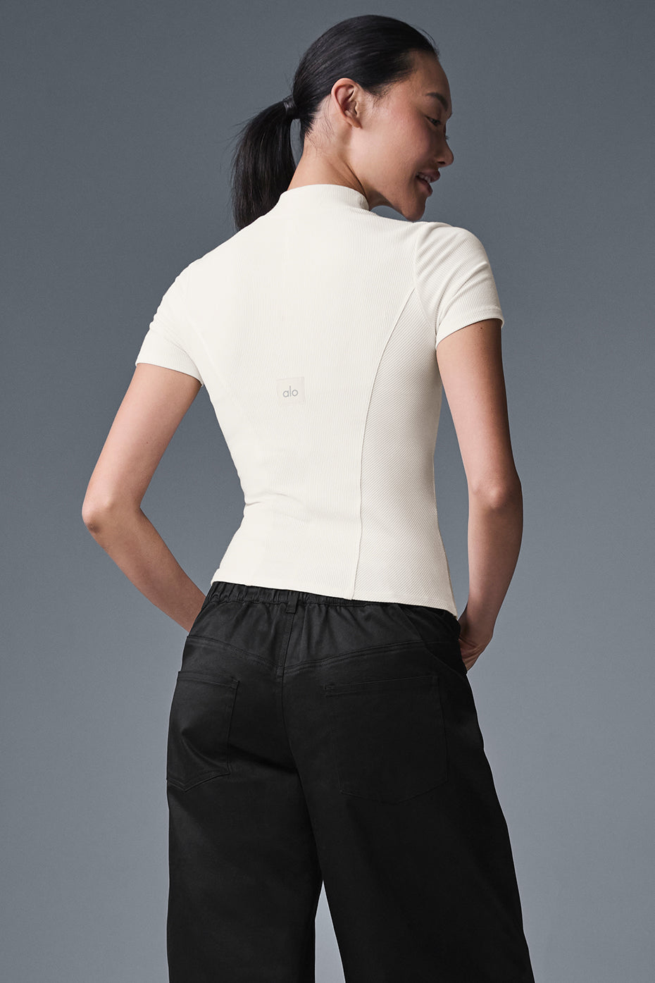 Back view of the ribbed short sleeve top, highlighting its elegant design.