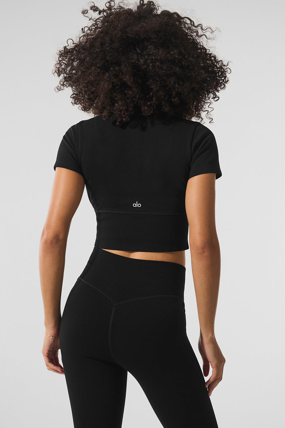 Close-up of the invisible zipper detail on the black crop top.