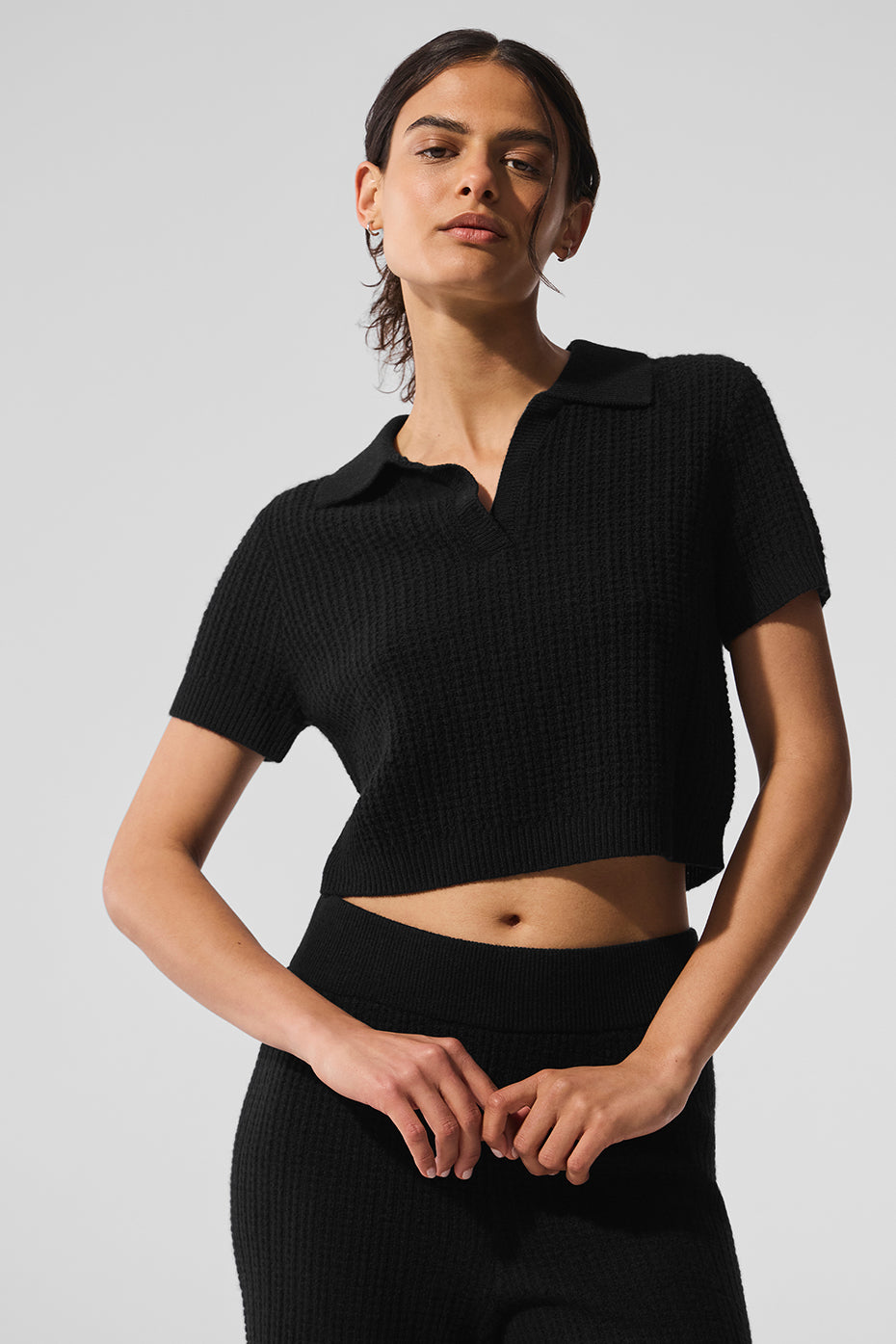 Close-up of the luxury black cashmere polo shirt’s waffle knit texture