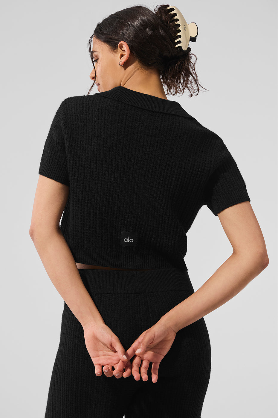 Side profile of the best cashmere polo tee for men layered under a blazer