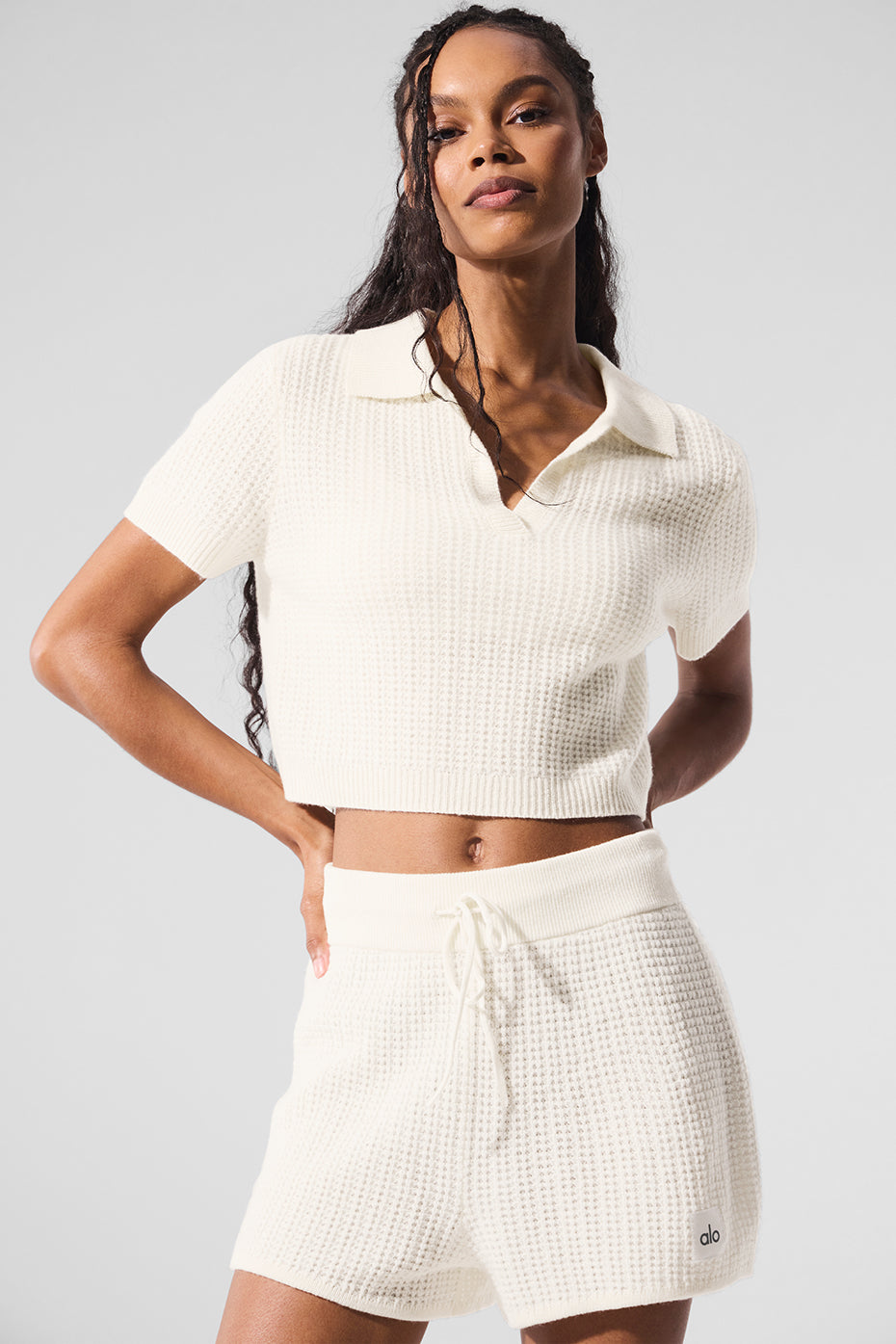Close-up of the ivory cashmere waffle knit polo shirt, showcasing its soft texture.