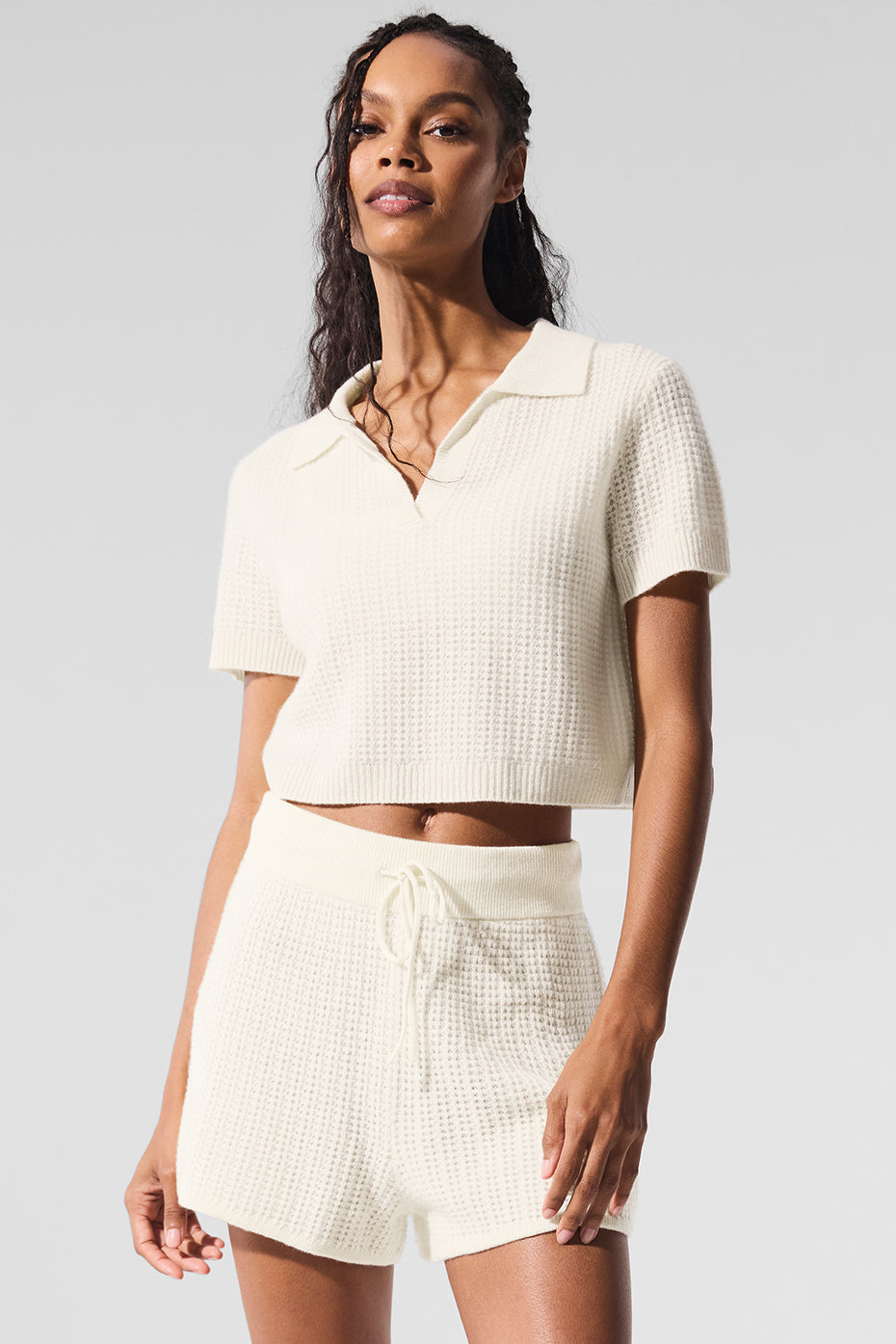 Close-up of the ivory cashmere waffle knit polo shirt, showcasing its soft texture.