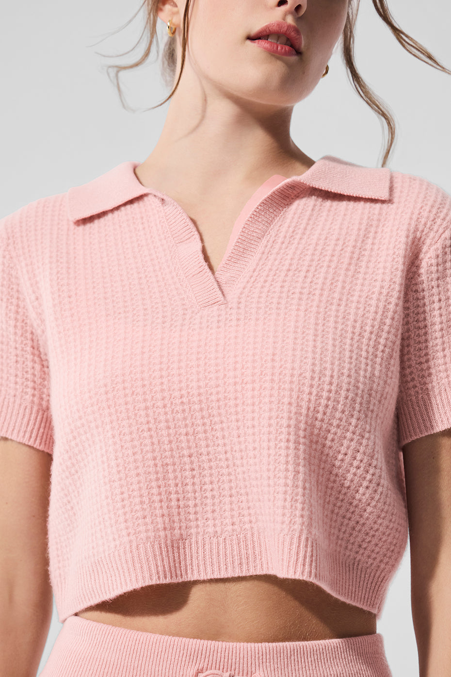 Front view of luxury cashmere waffle polo shirt in pink quartz.