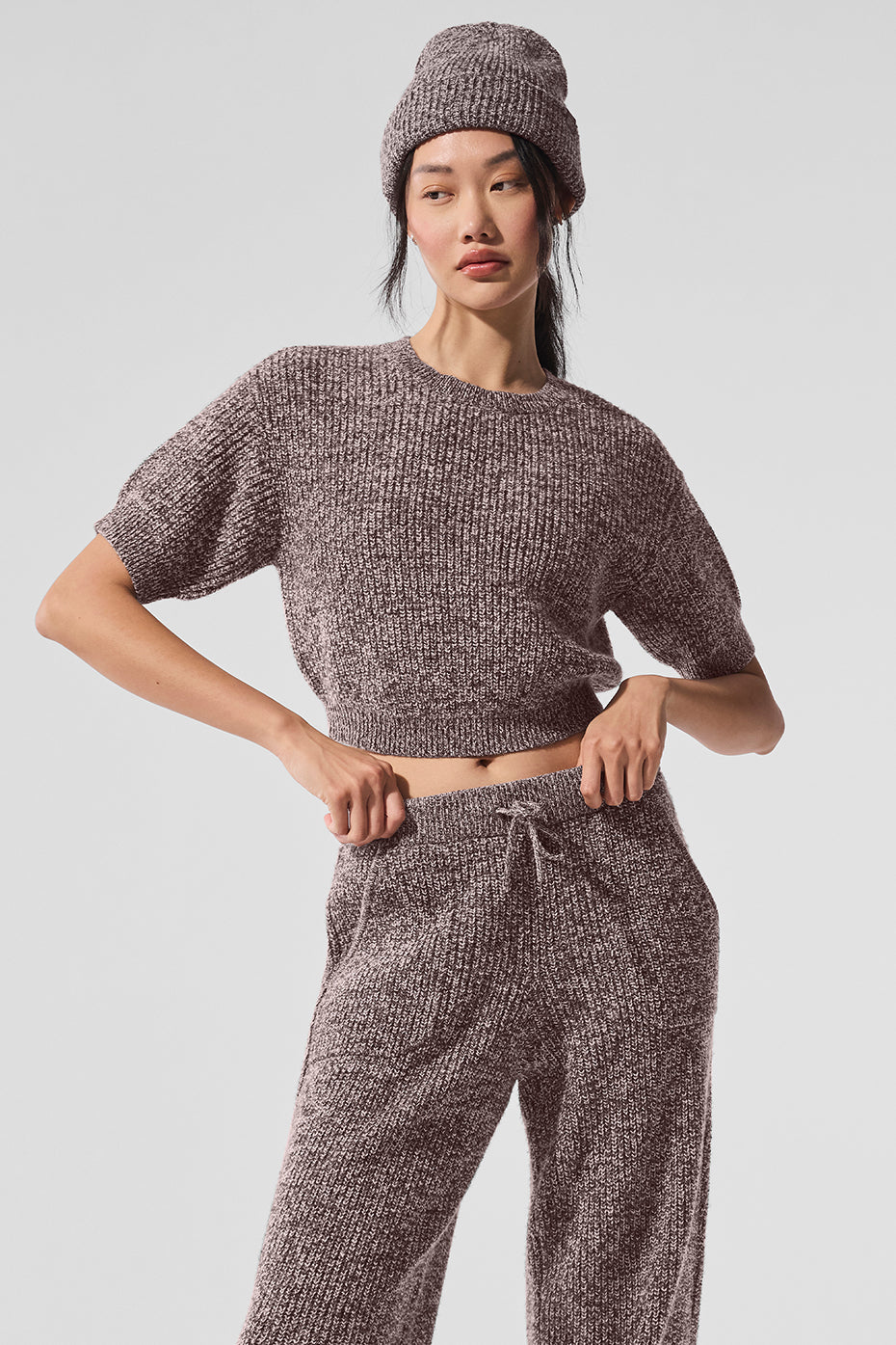 Front view of short sleeve sweater styled with leggings outdoors