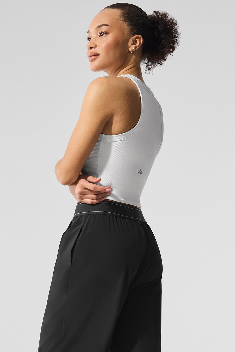 Model wearing the Goddess Ribbed Essential Tank with casual trousers.