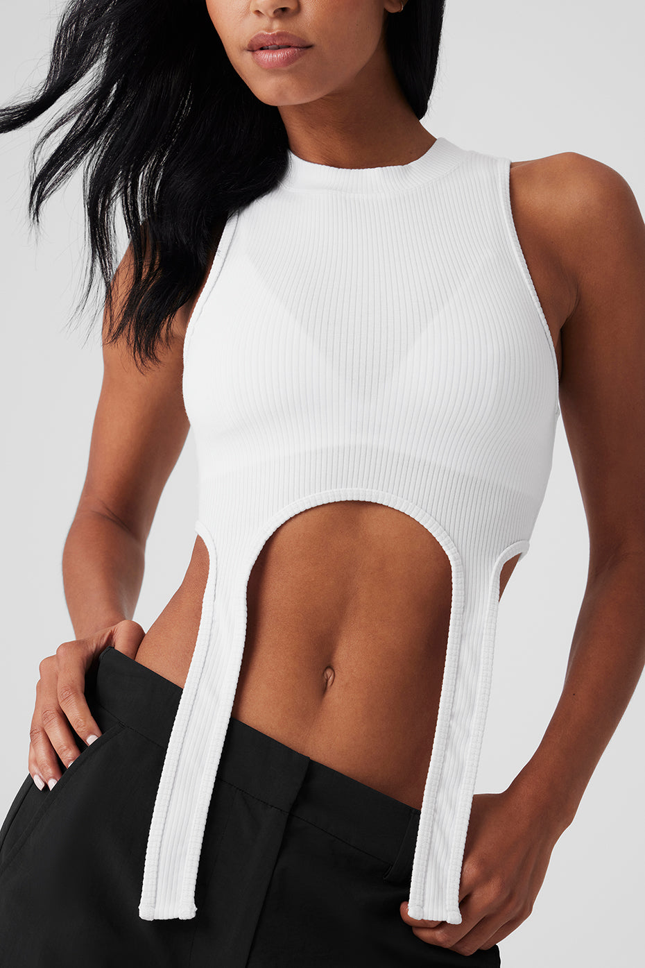 Front view of white ribbed tank top styled with jeans