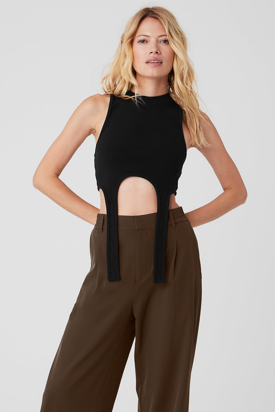 Front view of the black crop tank showcasing its unique design.