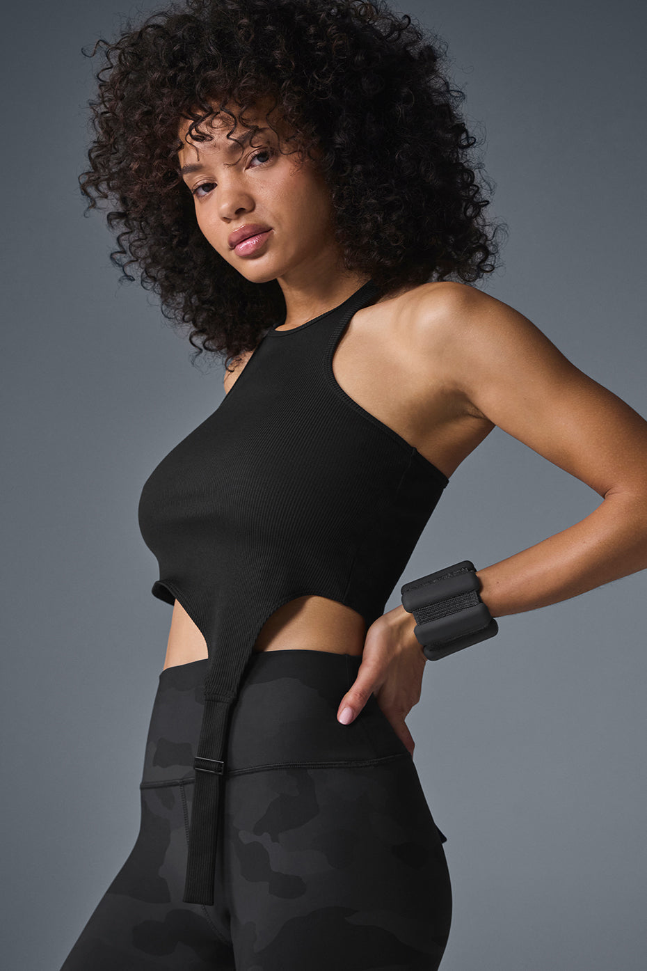 Model wearing the black tank top during sunset rooftop hangout