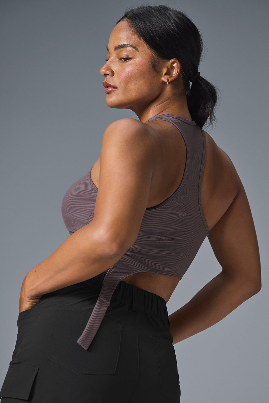 Model wearing the ribbed crop top with high neckline and racerback detail