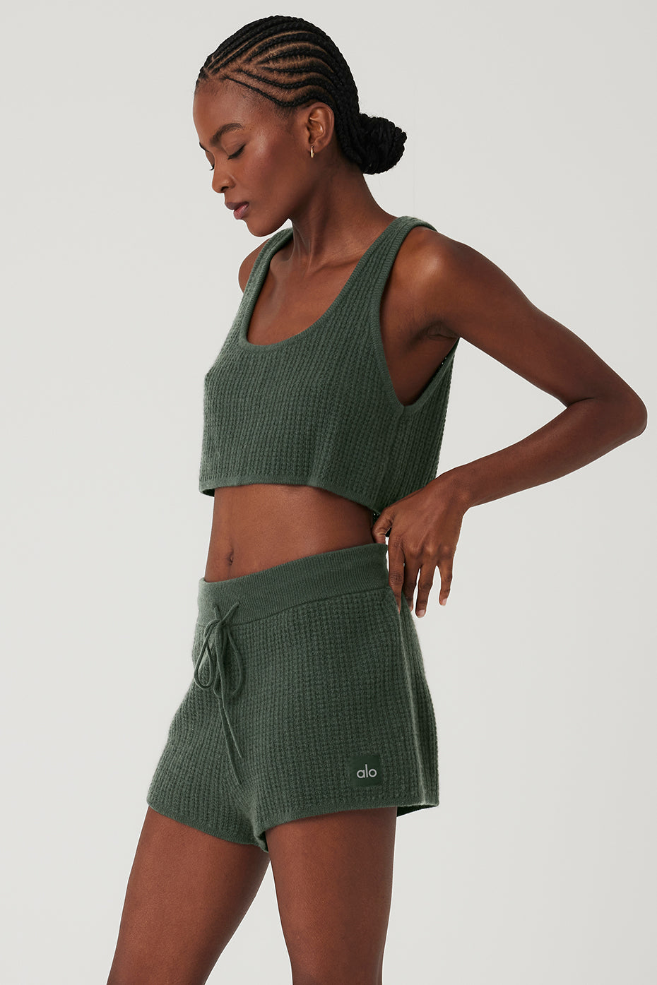 Styled with matching plush waffle shorts, perfect for lounging or casual wear in a cozy home setting
