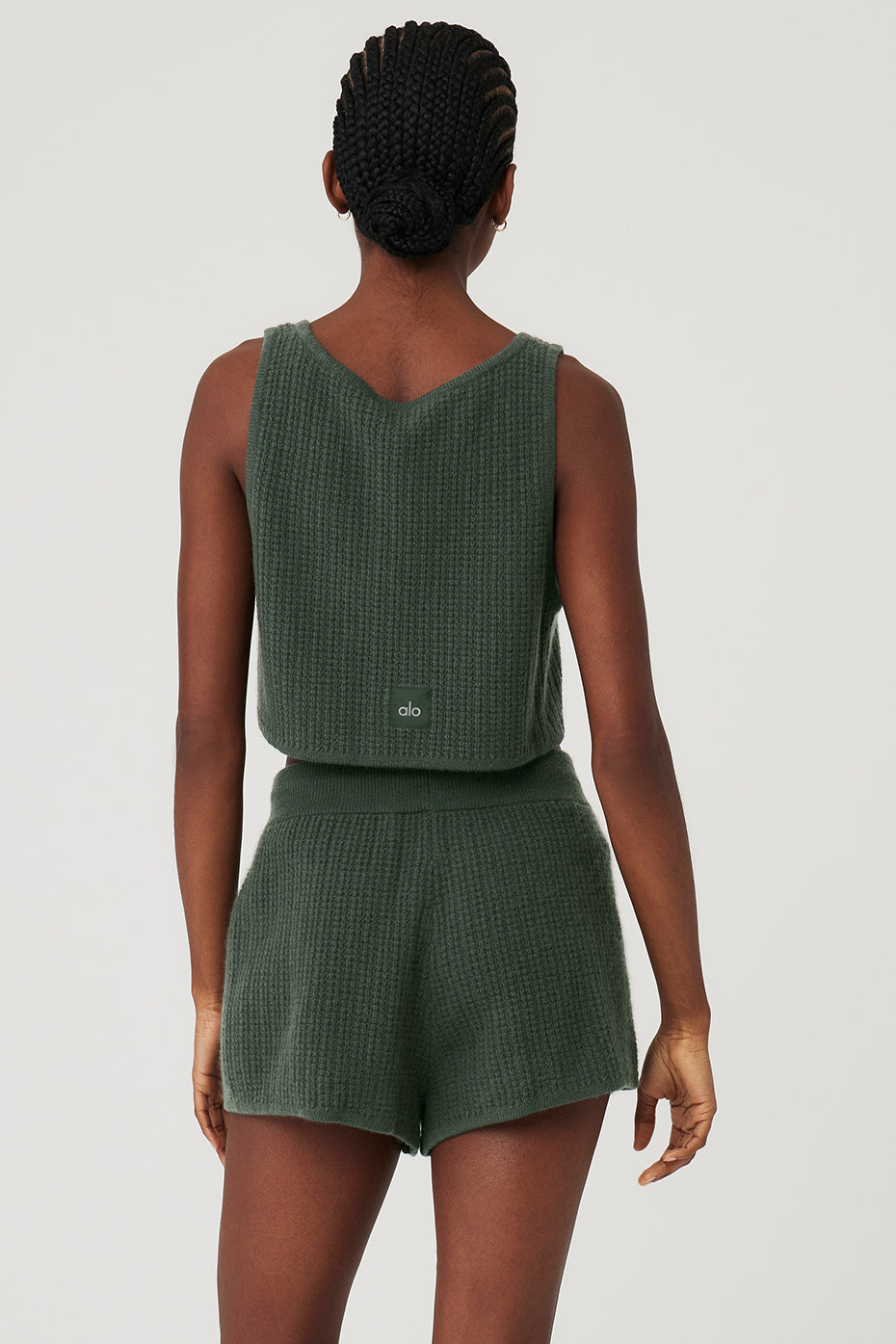 Close-up of the lightweight cashmere fabric and waffle texture of the cropped tank in dark cactus color