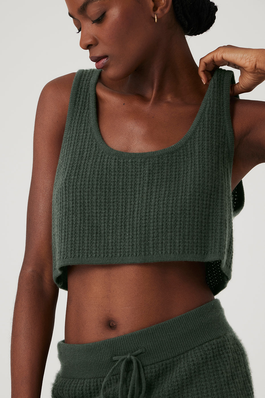 Front view of dark cactus cashmere plush waffle cropped tank on a model, showcasing its relaxed fit and scoop neckline