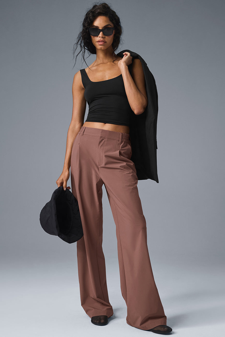 Side view showing the stretchy fabric of the sleeveless black tank top.