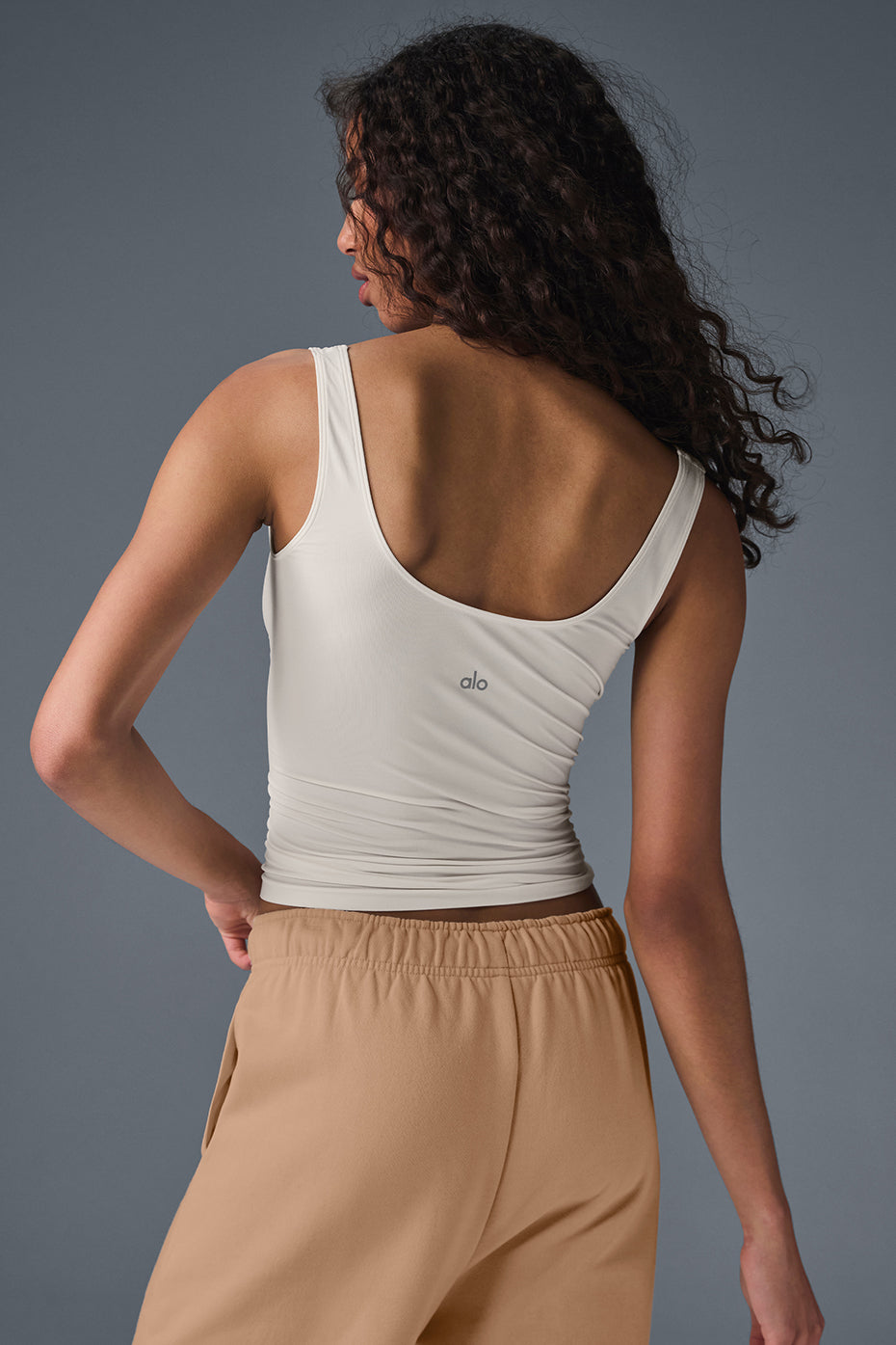 Back view of the Featherlight Sheer Glow Tank, showing the full-length hem and overall design.
