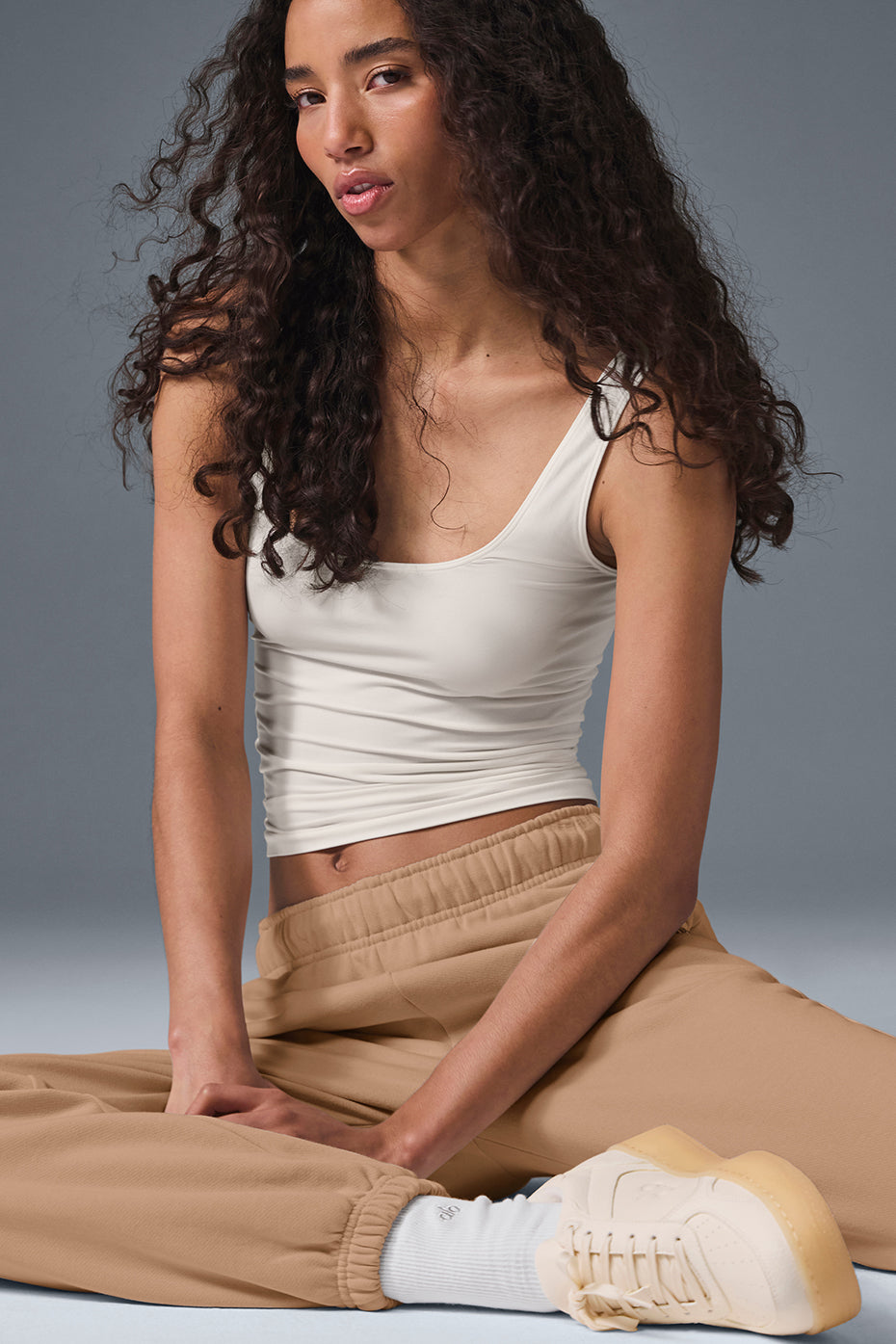 Side view of the Featherlight Sheer Glow Tank, demonstrating its lightweight fabric and fit.
