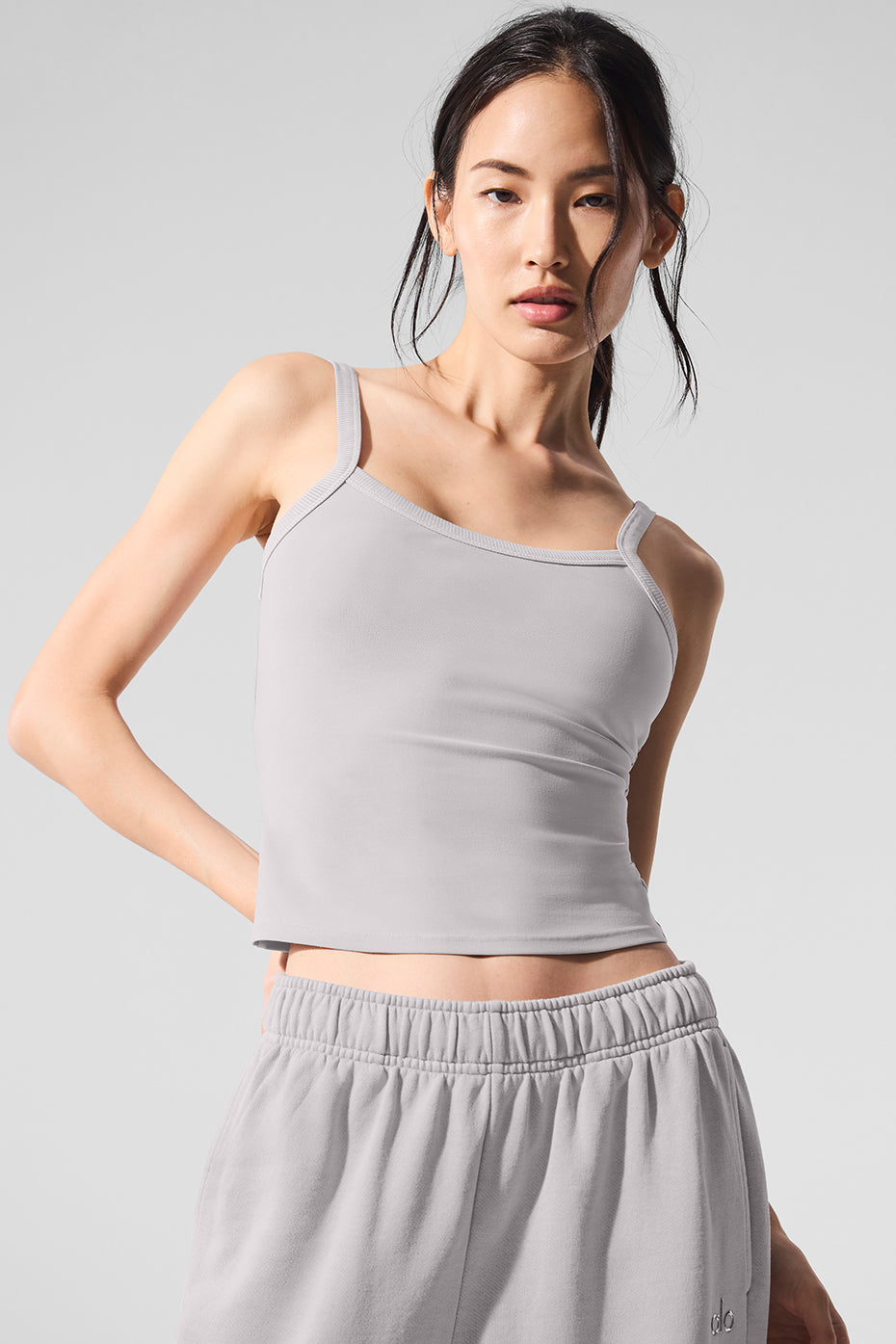 Back view of the grey tank top, highlighting its hip-grazing silhouette.